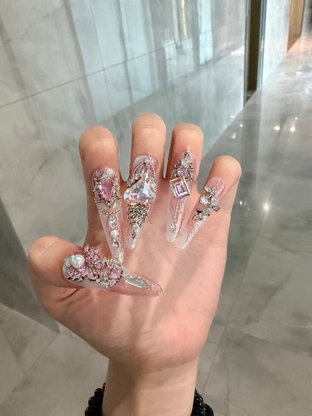 Pink crystal press-on nails worn for a finished look outside the salon